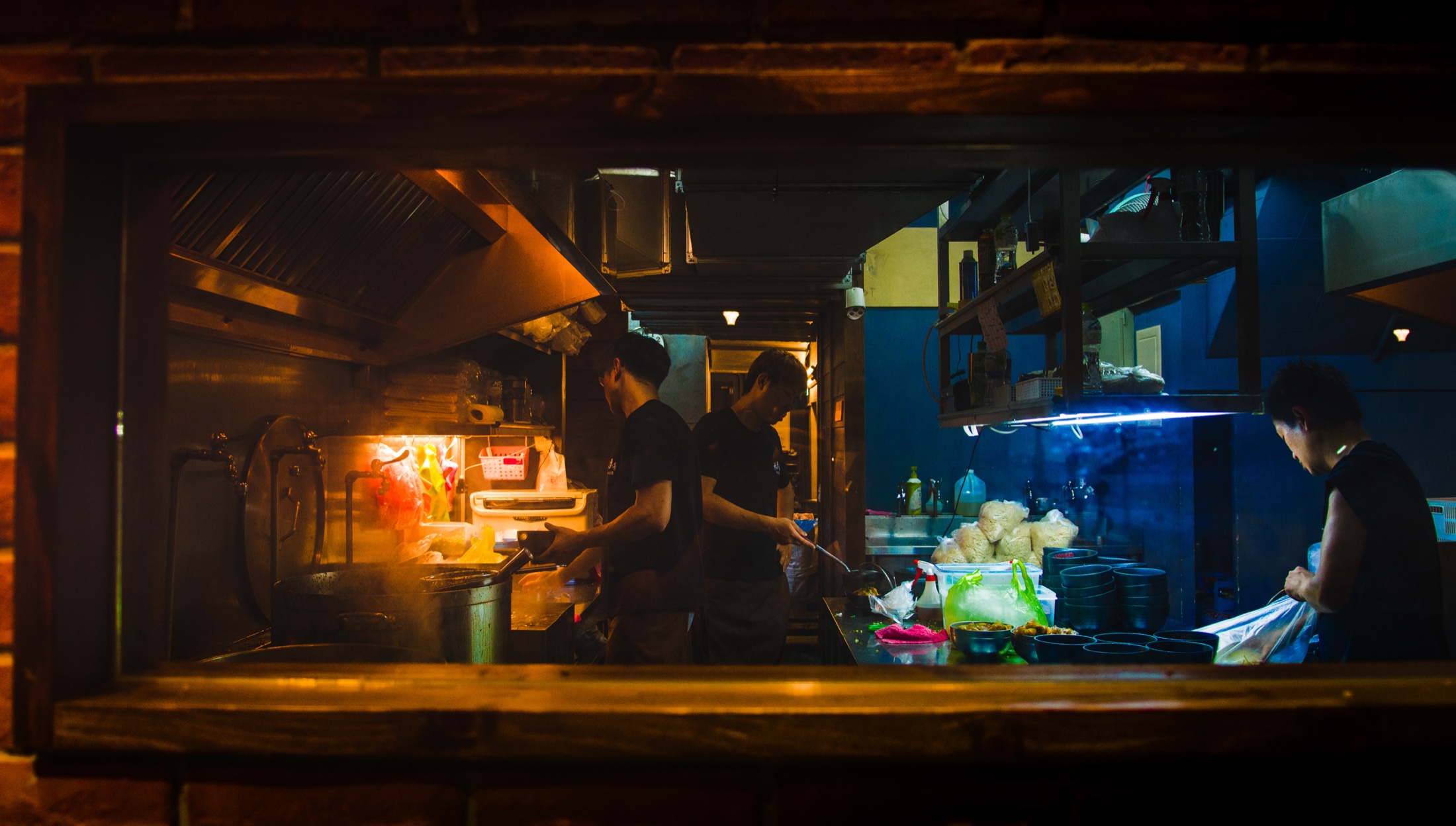 Cooks working inside a restaurant kitchen